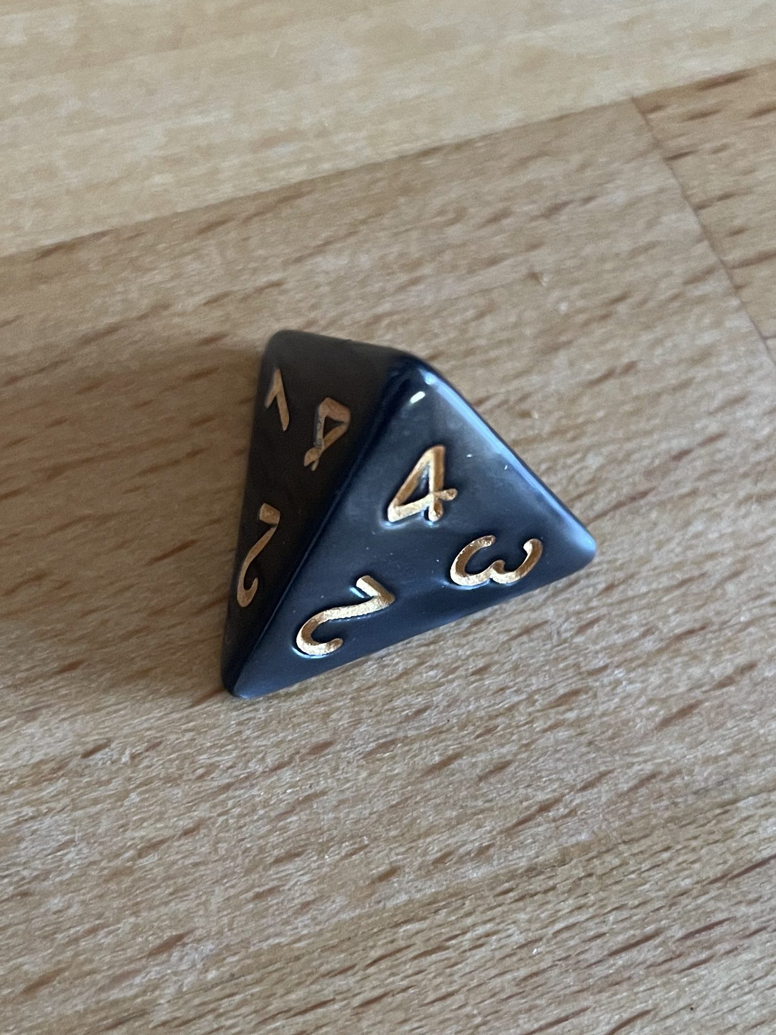 A pyramid die with four sides.