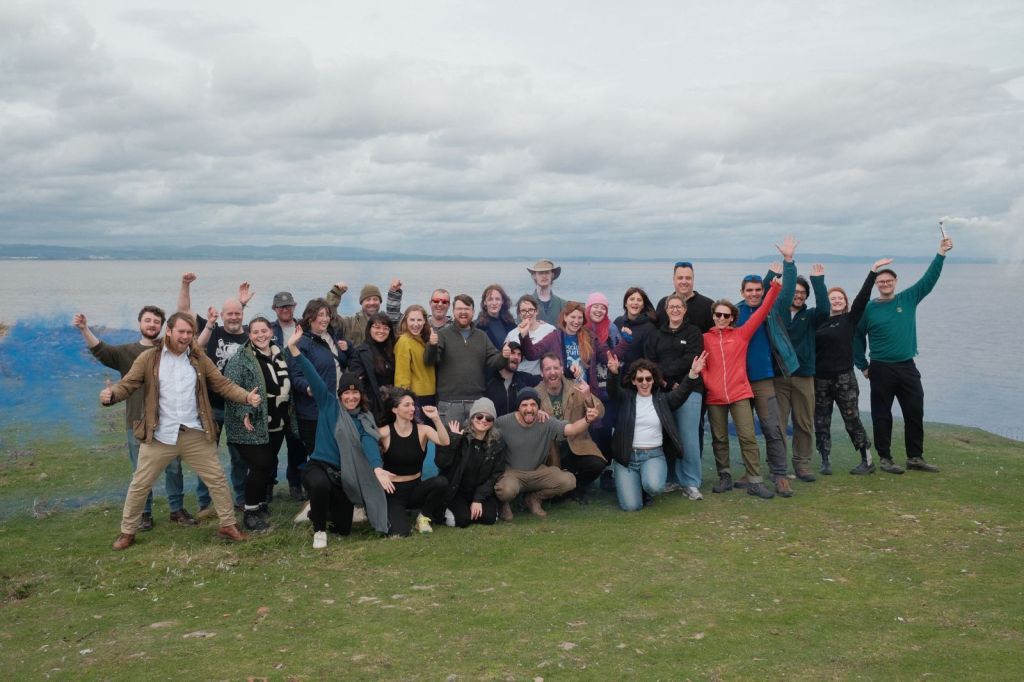 A photo of all the cast, crew and participants of The Static Sea. The estuary is in the background.